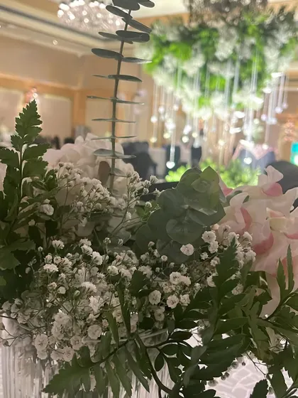 A close-up of the beautiful floral arrangements used in our "Wish Tree" decor, featuring delicate baby's breath and lush ferns.