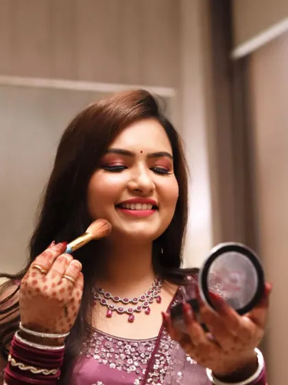 A happy moment during the getting-ready process. This bride is checking her makeup, looking radiant and confident for her Roka ceremony.