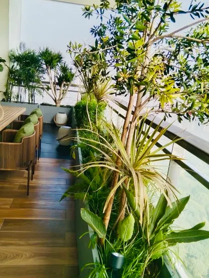 A view from the 38th floor gets better with greenery. This balcony garden with a dining table is an ideal place for a cozy Sunday lunch or afternoon tea.