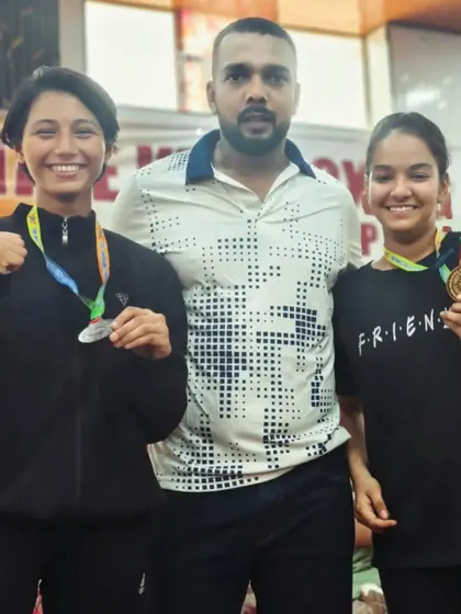 Two of my female students with their medals, showing the success that comes from hard work.