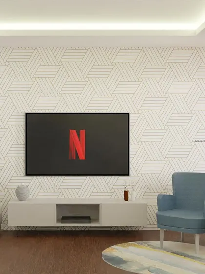 A concept for a minimalist living room with a geometric-patterned accent wall. The simple, low-profile TV console and single armchair create a clean and modern look, perfect for a Netflix night.
