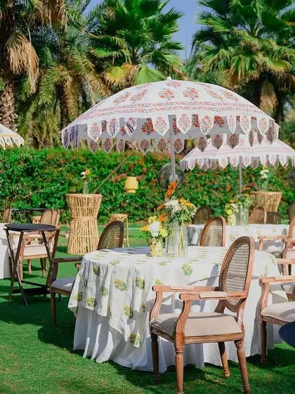 Woven cane details and block-printed fabrics create a rustic yet chic seating arrangement for this outdoor haldi.