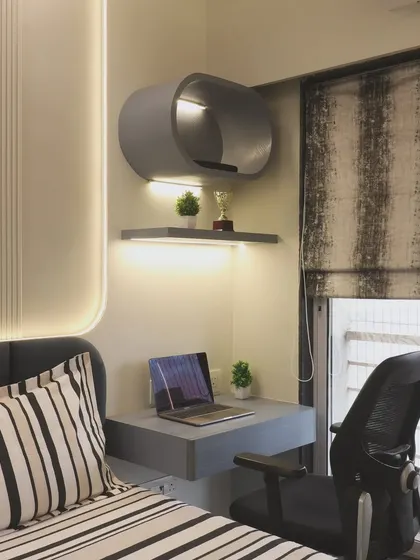 Another view of the bedroom study nook, showing how it fits neatly beside the bed. This solution is perfect for apartments where a separate home office is not possible, ensuring every square foot is utilized effectively.
