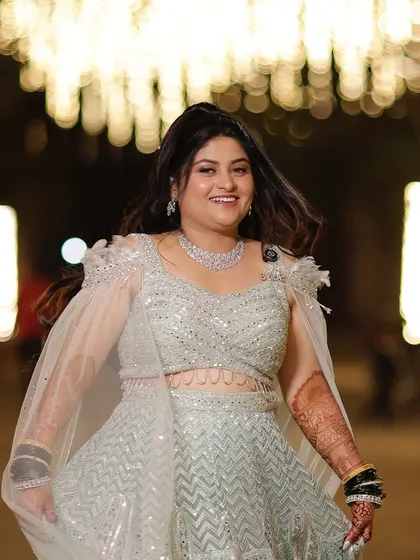 A beautiful, happy bride, ready to dance the night away. Her makeup is fresh, glamorous, and full of joy.