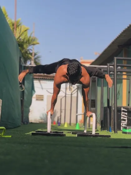 A full planche on parallettes. This is a peak static skill that takes years of dedicated training to achieve.