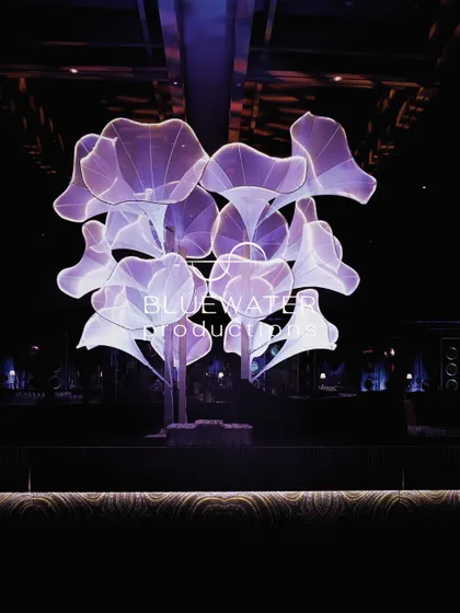 The floral light sculpture stands as a stunning centerpiece in the Sangeet hall.