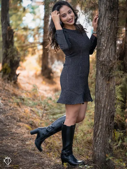 A playful and happy solo portrait of the woman in the forest, her pose full of life and energy.