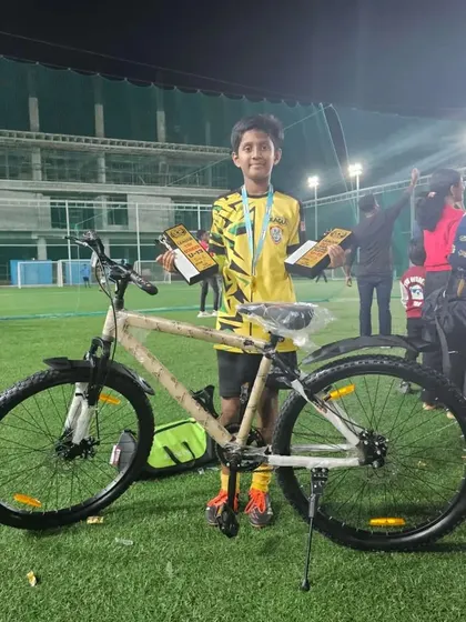 Abhay with his MVP and Top Scorer awards from the Mini Dribblers League, along with a new bicycle for his achievement.