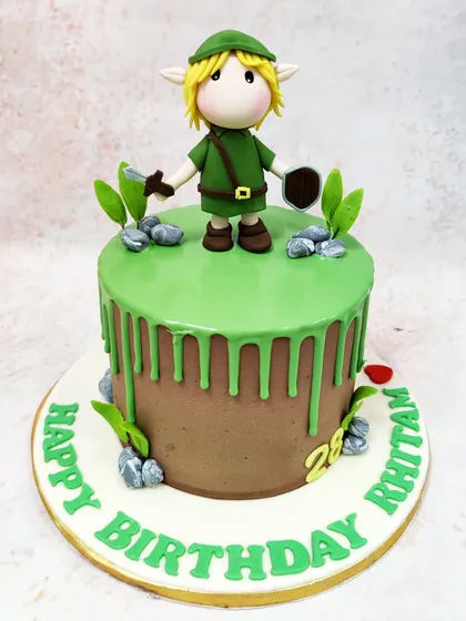 We venture into the land of Hyrule with this Legend of Zelda inspired cake. A detailed fondant figure of the hero, Link, stands ready for adventure on a field of green drip icing, making this the perfect quest for any video game enthusiast's birthday.