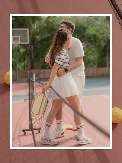A stylish, framed shot from a pickleball pre-wedding shoot, perfect for a modern, sporty couple.