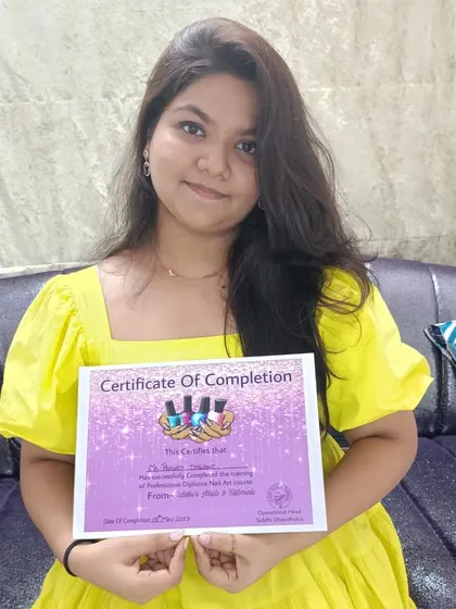 A proud moment for a student who has just completed the Professional Diploma Nail Art course. This certification marks her entry into the professional nail industry.