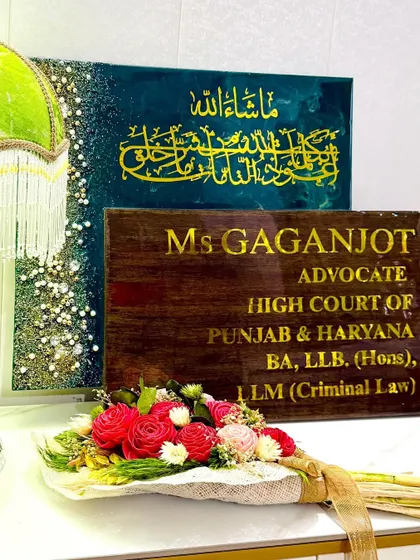 A different view of the advocate's office plaques, highlighting the contrast between the spiritual art and the professional nameplate.