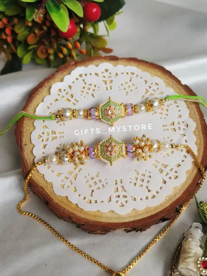 A beautiful pastel green and purple meenakari Rakhi set for your brother and sister-in-law.