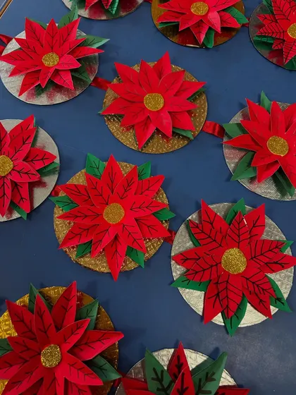 A closer look at the beautiful paper poinsettia ornaments. The gold and silver details add a lovely festive touch.