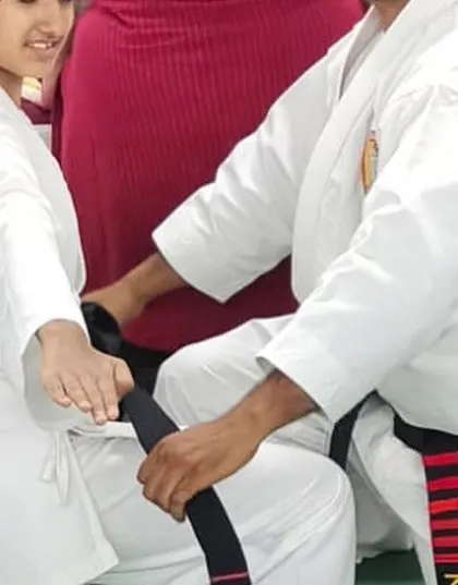 A special moment as a student is awarded her black belt. This is the culmination of years of dedication, discipline, and perseverance.