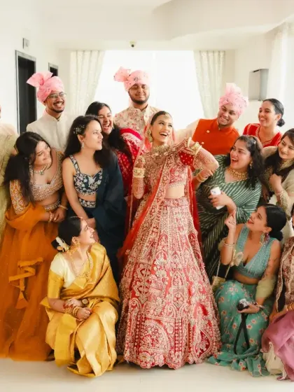 The bride and her entire bride and groom squad pose for a fun, chaotic group photo. This image is full of energy and shows the love and support surrounding the couple.