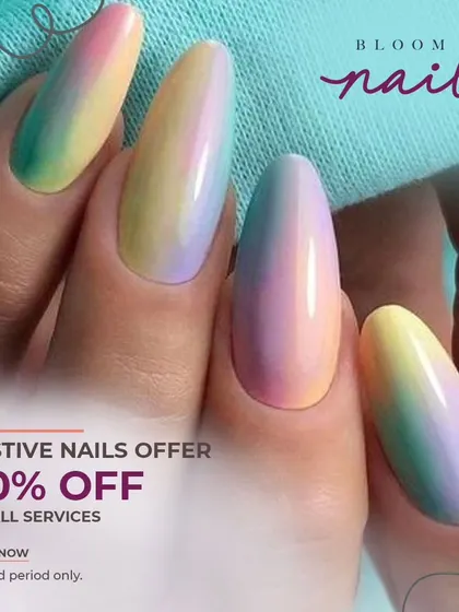 A full view of the hand with the pastel rainbow ombré nails, showing how they look against a light background.