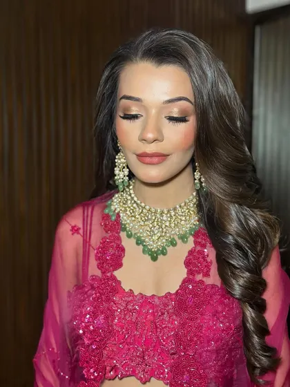 A close-up of Tanisha's eye makeup, with her eyes closed to show the seamless blending of warm, sultry tones.