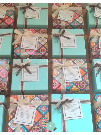A top-down view of multiple employee promotion hampers, showcasing the consistent and beautiful packaging I provide for bulk orders. Each gift is carefully wrapped to ensure a uniform and impressive presentation.