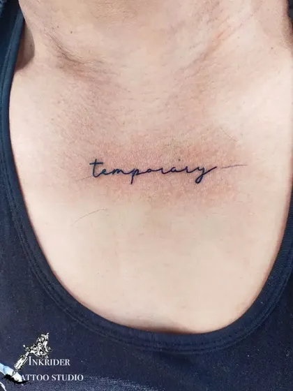 The word 'temporary' inked on the chest. This tattoo serves as a powerful reminder of the transient nature of things, good or bad.