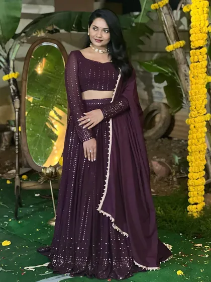 A model wearing a deep purple lehenga with all-over sequin work, perfect for a glamorous reception or cocktail party.