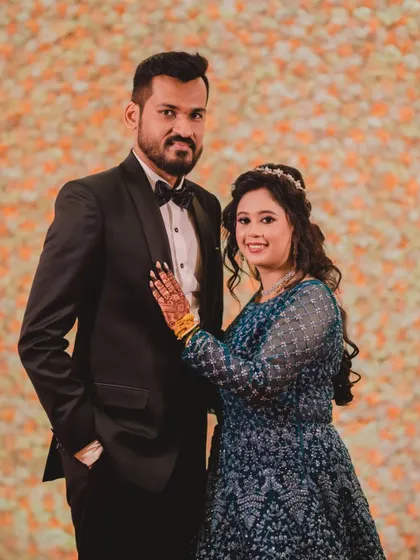 A picture-perfect couple at their reception. Her blue gown is paired with a soft glam makeup look and a delicate tiara, making her look and feel like a princess.