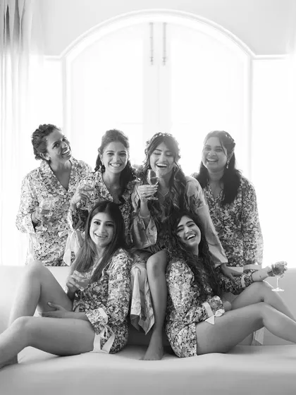 A joyful black and white shot of Larissa and her bridesmaids sharing a laugh. This captures the fun and friendship of the getting-ready process.