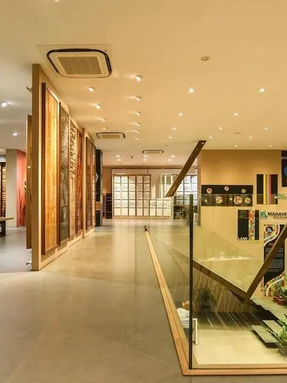 A comprehensive look at a conventional commercial space, highlighting the double-height reception, glass-walled mezzanine, and various product display areas designed for a modern business.