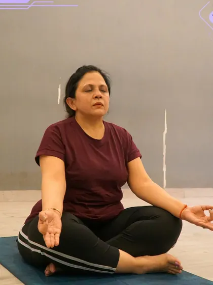 A member in a deep meditative state during a yoga class. This photo embodies the peace and mindfulness that our yoga sessions aim to cultivate.