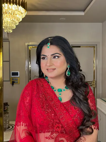Another angle of this beautiful bride in red. The look is timeless, featuring classic eye makeup and a flawless complexion that lets her natural beauty shine.