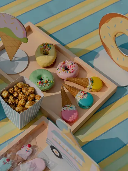 A tray of colorful donuts and ice-cream-cone-macarons, showcasing the creativity of our pastry team.