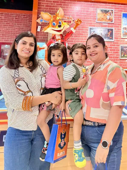 A family gets a photo opportunity with J the Fox. He's always happy to pose for a picture to remember your visit.