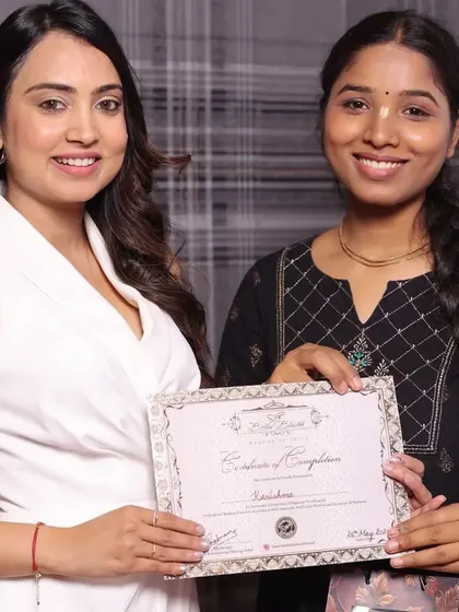 A happy student on her graduation day, certificate in hand.