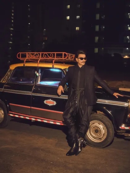 Another angle of Ranveer's powerful look. The styling is confident and edgy, perfectly matching his dynamic personality. This is a great example of modern celebrity menswear.
