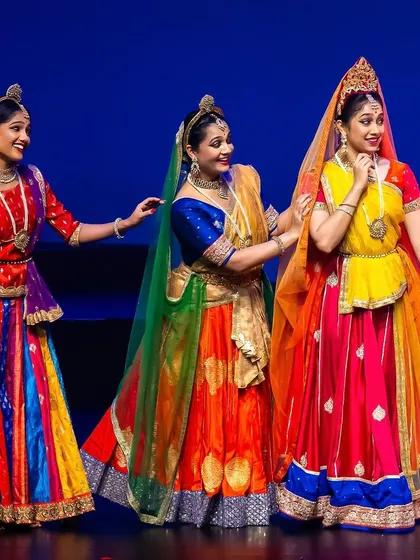 A celebration of color and camaraderie on stage. This group performance highlights the joy and unity of the gopis, with vibrant costumes and synchronized movements that fill the stage with energy.