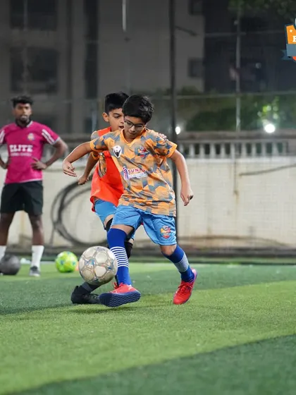 A player shields the ball from a teammate in a practice drill, honing his strength and ball-retention skills.