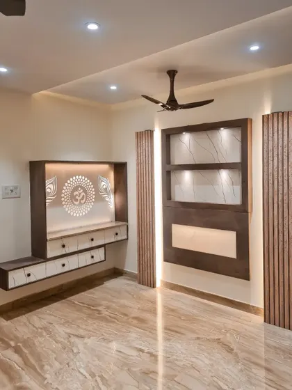 A closer look at the custom pooja and display unit in this earthy-themed living room, featuring backlighting and clean lines.