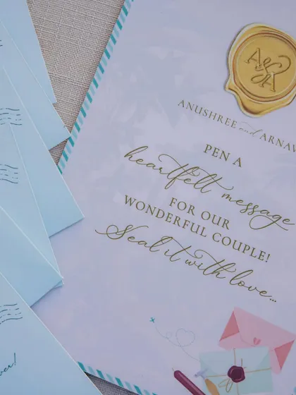 Elegant stationery inviting guests to 'Pen a heartfelt message for our wonderful couple!'. The custom wax seal adds a touch of classic romance.