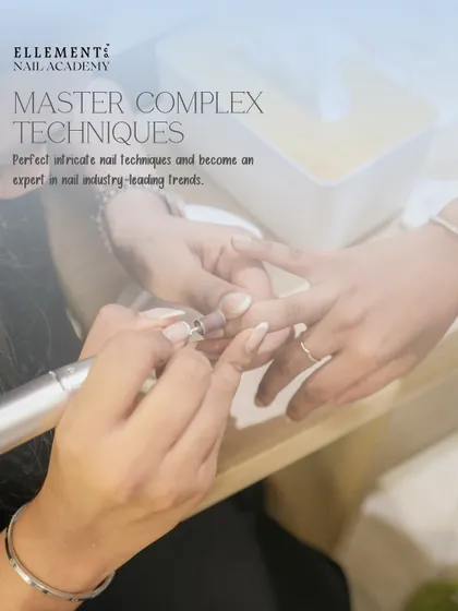 Master complex techniques with us. Here, a student is perfecting her skills with an e-file under the watchful eye of a trainer.