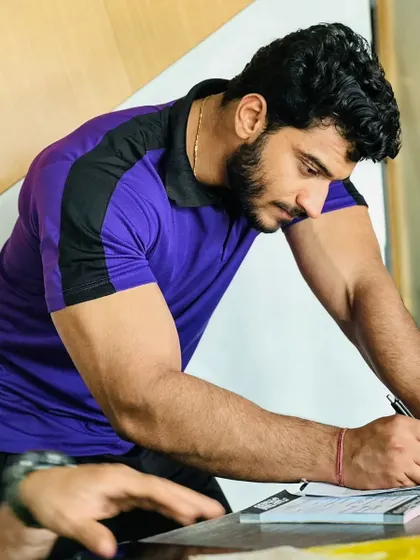 Taking notes and creating a personalized workout plan. Every client gets a plan built for their specific goal, whether it's a fat loss workout or a muscle gain transformation.