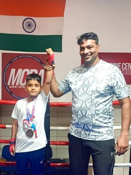 Coach Darshak Pawase raising the arm of our little champion, Devansh Gayake. Every victory, big or small, is celebrated here.