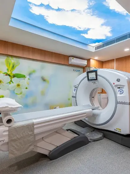 This diagnostic room at the NRDC, equipped with advanced imaging technology, is designed to be calming. The ceiling features a backlit image of a sky, a design intervention intended to ease patient anxiety and create a more positive experience.