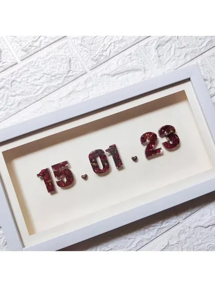 A minimal shadow box frame featuring a wedding date made from preserved varmala flowers. It's a simple, beautiful, and budget-friendly way to cherish your special day.