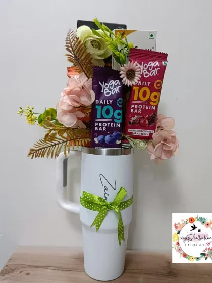 A clear shot of the personalized Stanley mug bouquet, showing the name 'Zain' and the arrangement of protein bars and chocolates.