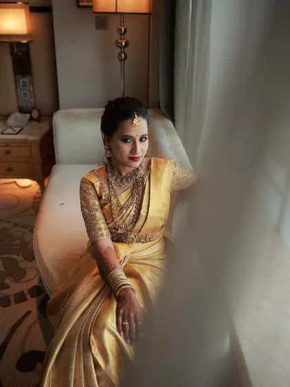 An artistic shot using natural light and shadows. The makeup looks sophisticated and elegant, adapting beautifully to different lighting conditions.