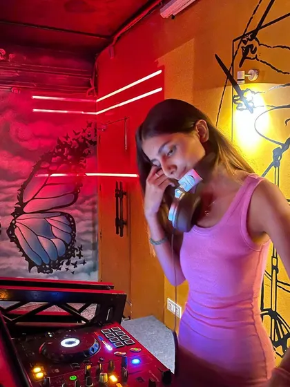 In my element at Beer Tales in Dehradun. The venue's cool butterfly and drum murals, combined with the red neon lights, made for a really unique and vibrant DJing experience.