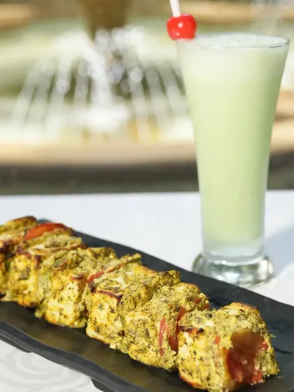 One of our crowd favorites, the Paneer Minty Lemon Tikka. Soft paneer cubes are marinated in a zesty mix of mint and lemon, then grilled to achieve a perfect smoky char. It’s a refreshing and flavorful starter.