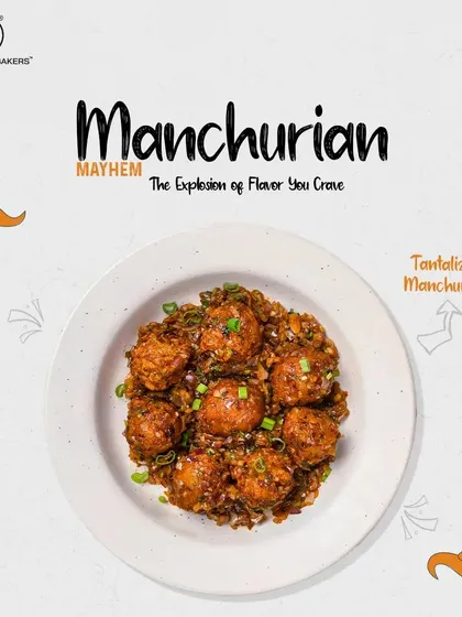A bowl of our dry Manchurian, highlighting the glossy sauce and fresh garnish. Each bite is an explosion of flavor.