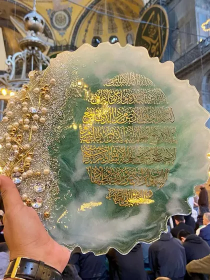 Capturing the beauty of my art in a place of immense spiritual significance. This photo was taken inside Hagia Sophia, with my Ayat al-Kursi plaque held up against the backdrop of the prayer hall.