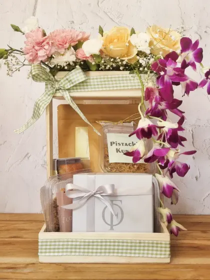 A stunning Mother's Day gift box, overflowing with fresh orchids and carnations, alongside our gourmet snacks. It's a beautiful way to show how much you care.